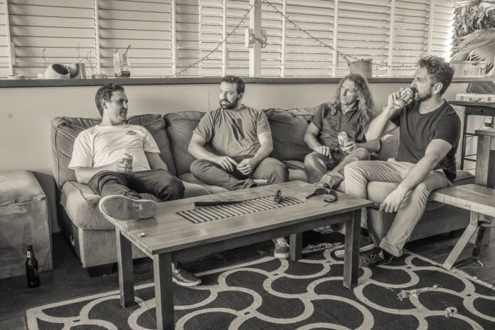 Group of people sitting on a couch captured in a black and white Poison Oak photoshoot.