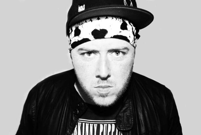 A black and white photo of a man wearing a bandana.