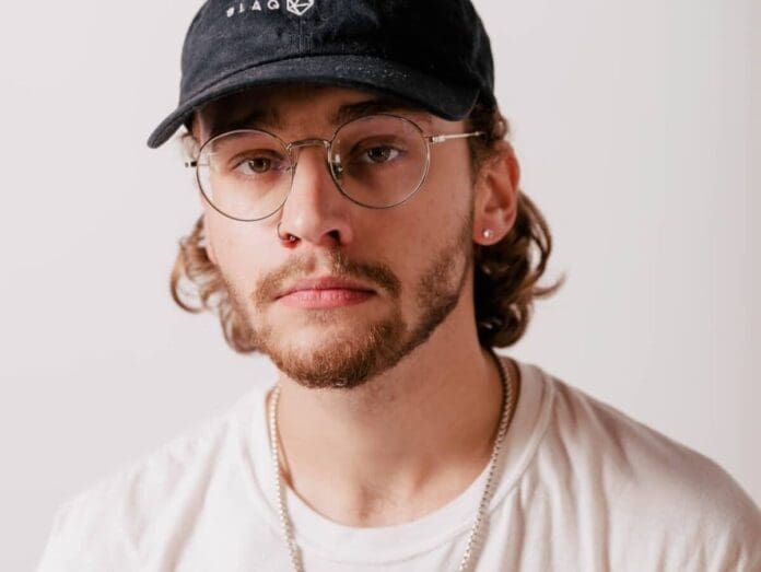 A man wearing glasses and a baseball cap.