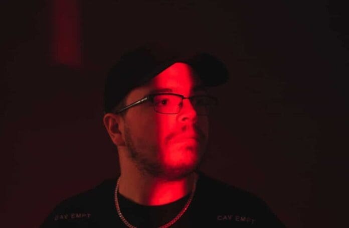 A man in front of a red light ascends.