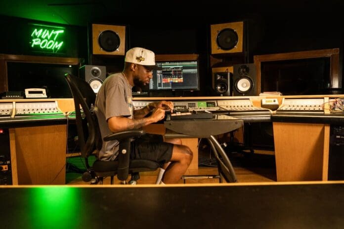 A man utilizing Serato's revolutionary Sample 2.0 in a recording studio.