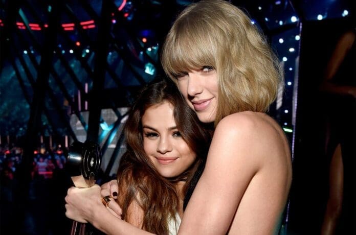 Selena gomez and taylor swift hugging at the mtv awards.