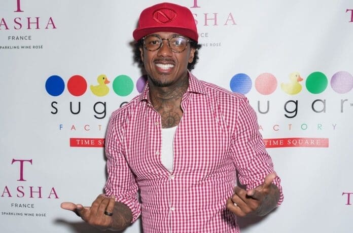 A man in a red shirt and hat is posing for a picture during Nick Cannon's skit.