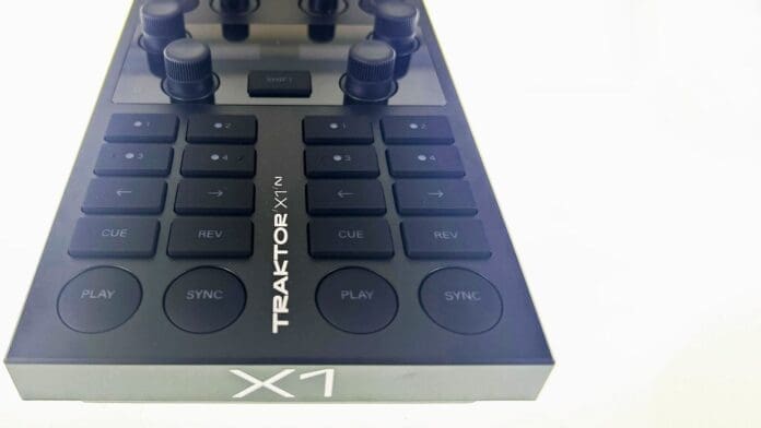 Traktor X1 MK3 - a black dj controller with buttons.