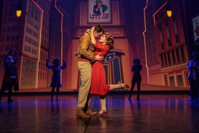 The cast of 'Rogers: The Musical' passionately kiss on stage in the musical's performance.