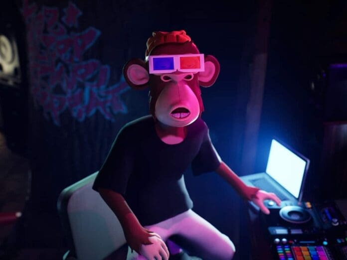 A monkey wearing 3D glasses is sitting in front of a computer.