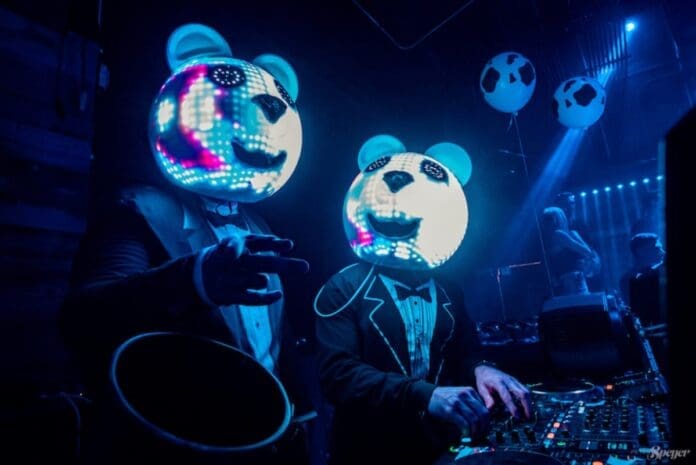 Two Electric Polar Bears DJs wearing panda masks perform at a party.