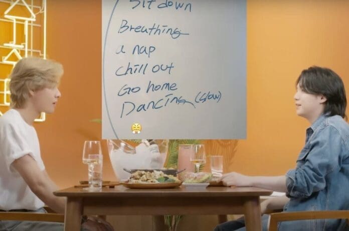 Suga, RM, and J-Hope writing on a board.