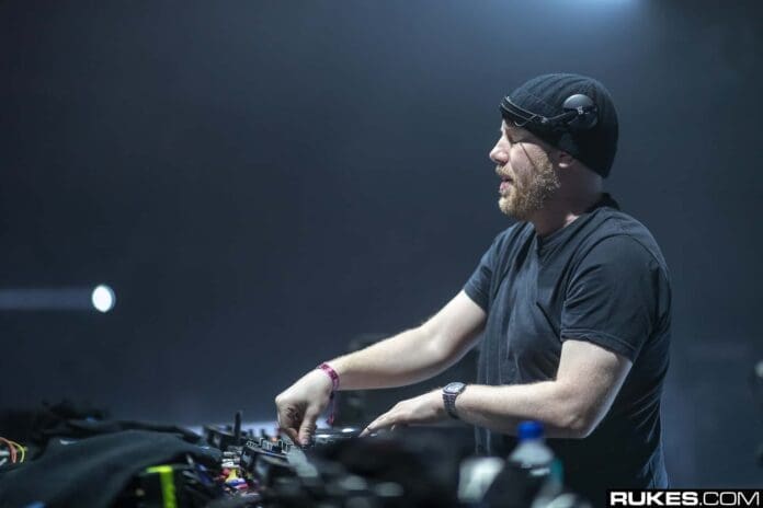 A man in a black beanie is playing a dj set at Creamfields North 2023