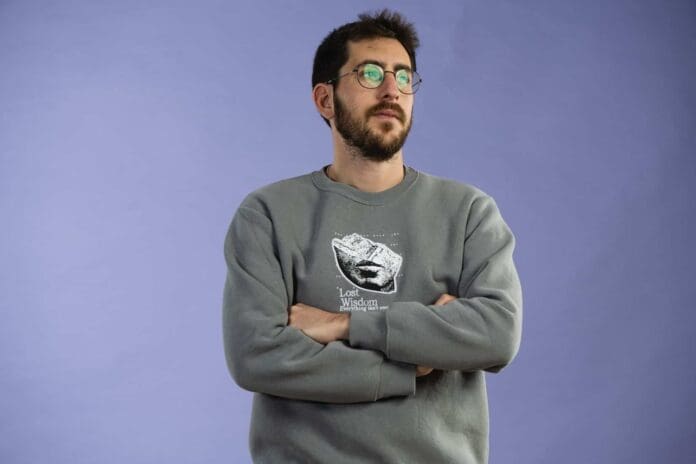 A man in glasses wearing a grey sweatshirt unveils new single ‘African Vibes’ into the world: Listen.