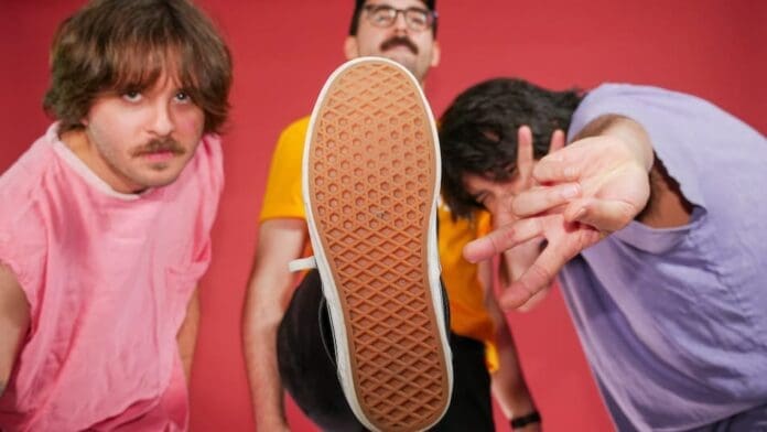 A group of men, MOLD!, are posing for a photo showcasing their Peruvian heritage.