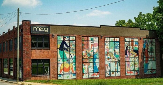 A brick building with a mural on it that is part of Moog Music parent company inMusic.