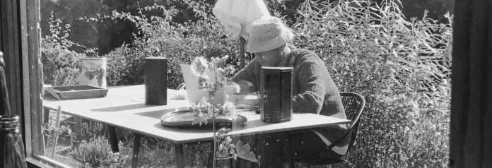 A woman sits at a table.