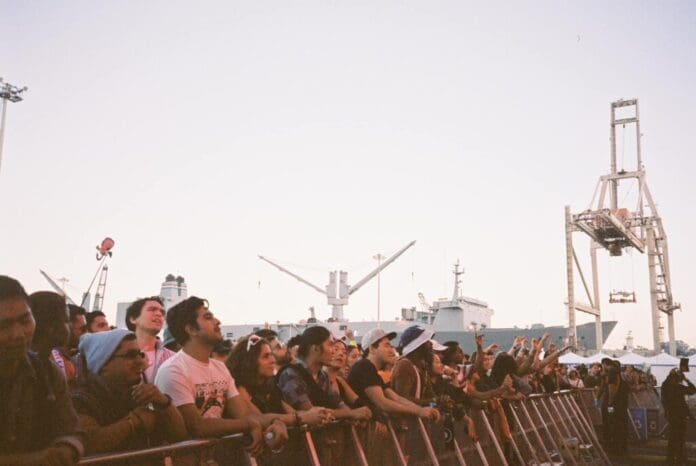 A crowd of people watching Portola Festival 2023 concert in front of a ship.