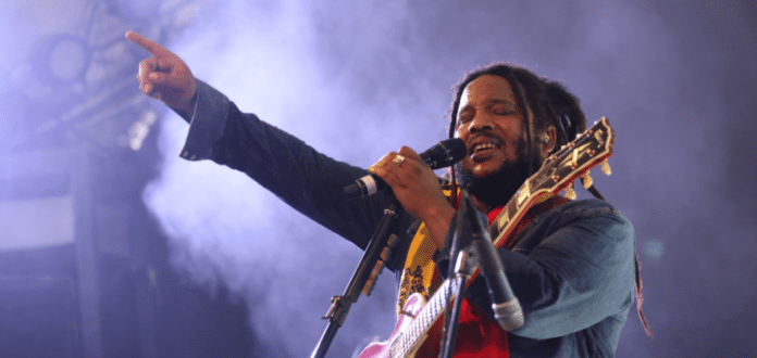 Stephen Marley's 'Old Soul' concert features a man with dreadlocks singing into a microphone.