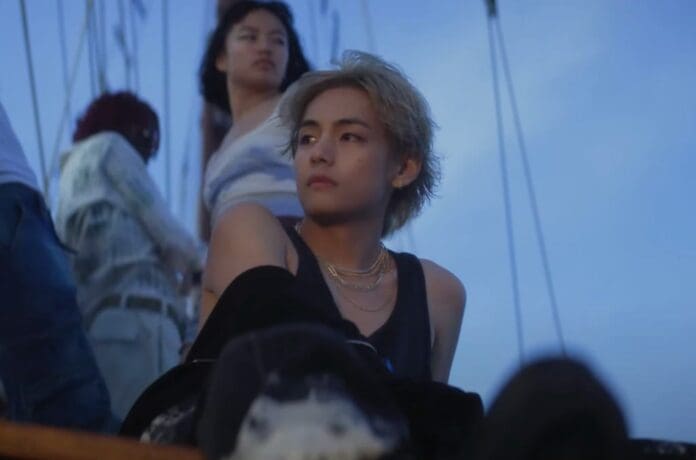 Watch a group of people in V's 'For Us' music video sitting on a boat.