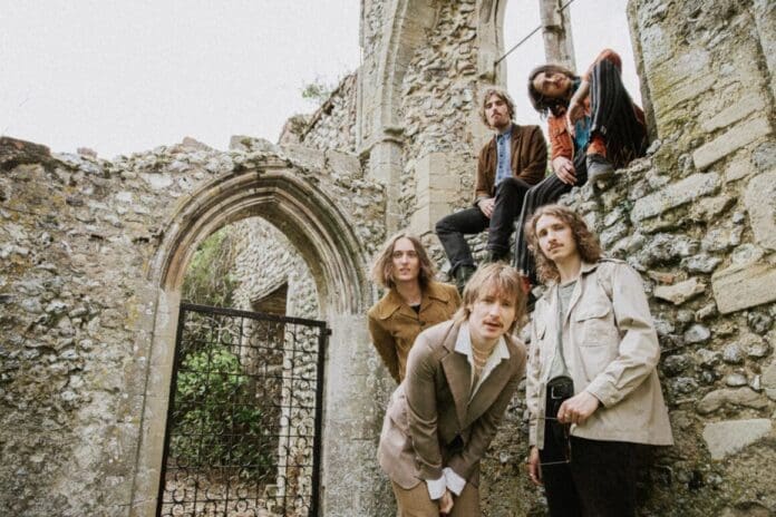 A group of people posing in front of an old building, showcasing versatile artistry on 