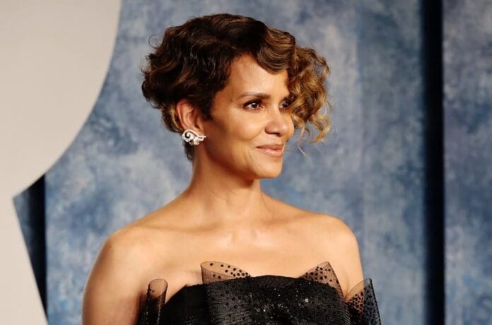 Halle Berry smiles at the camera.