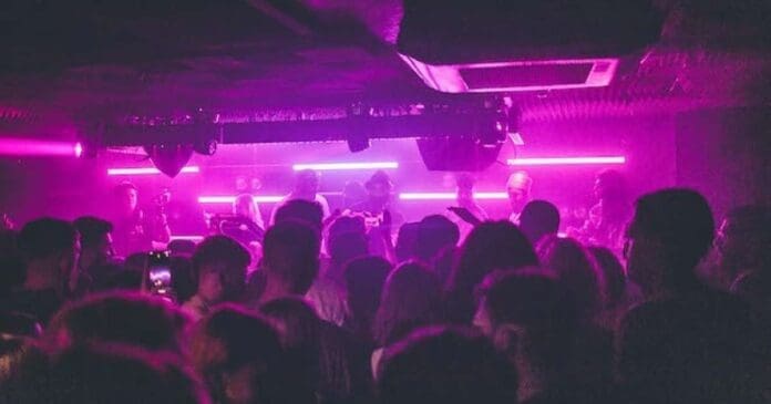 A crowd of people in a dark room.