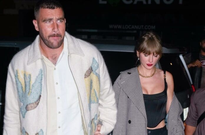 Taylor Swift and a man holding hands.