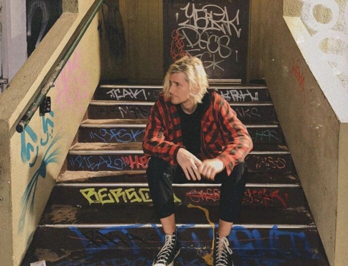 A man sitting on a set of stairs.