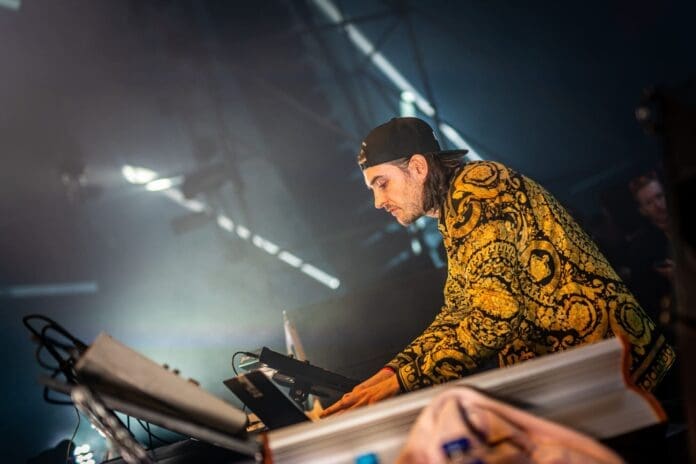 A man playing a keyboard at a music festival.