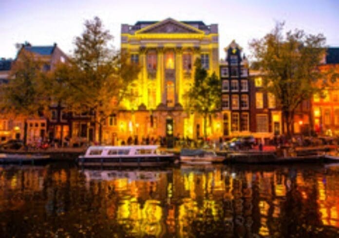 Amsterdam at dusk with boats on the canal, Juba