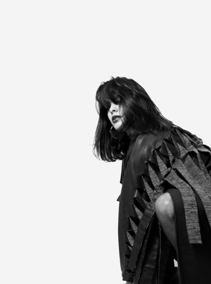 A black and white photo of a woman posing during her Boiler Room debut.