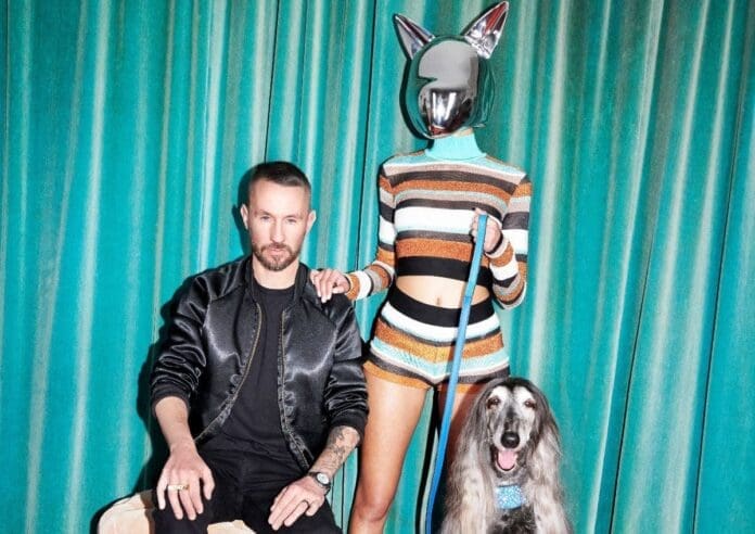 A man and woman posing with a dog, forming a dreamteam.