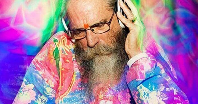 Goa Gil, a long-bearded man and a Psytrance pioneer, passionately listens to music.