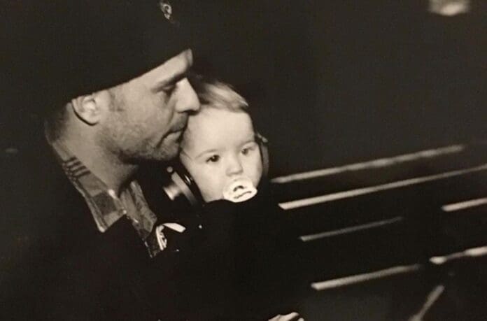 Tragically Hip frontman Gord Downie's daughter reminisces about her late father in an old photo of a man holding a little girl.