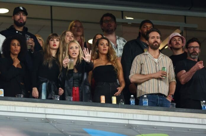 A group of people watching a game at a stadium.