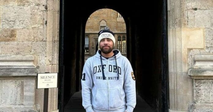 A man in a hoodie studying at Oxford University.