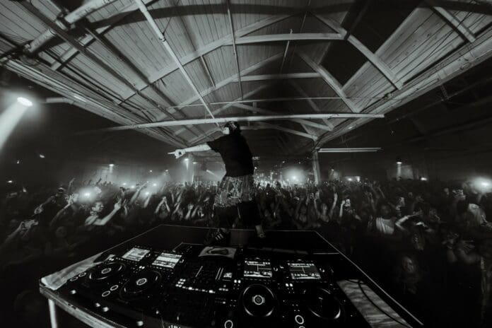 A Must-See black and white photo capturing Knock2, as he performs live on his Room202 Tour to an ecstatic crowd.