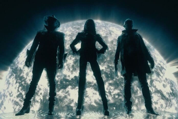 A group of people standing in front of a full moon, eagerly awaiting NERO's epic single from their upcoming album.