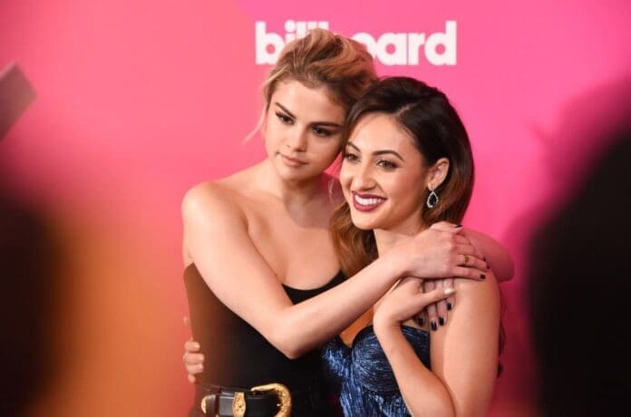 One woman hugging Selena Gomez on the red carpet at the Billboard Awards.