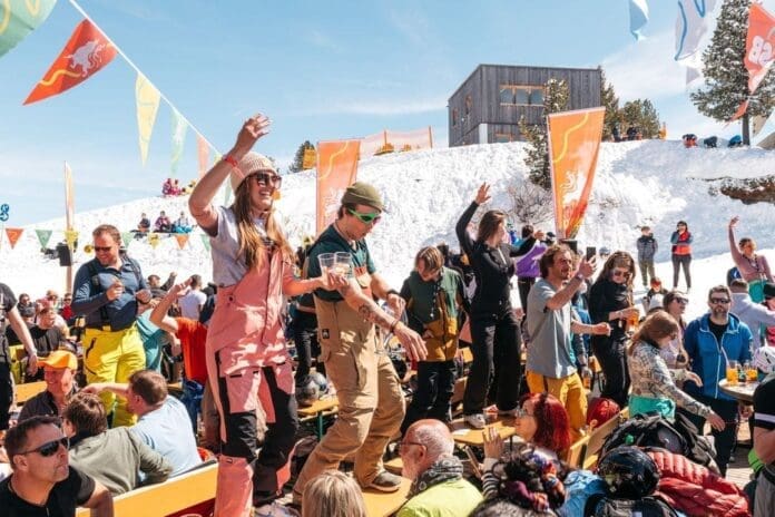 A group of people on a ski slope at Austria's Snowbombing Festival.