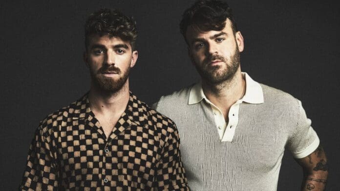 Two men standing next to each other in front of a black background while The Chainsmokers drop their groovy new single with GRACEY, titled 'Think of Us': Listen.