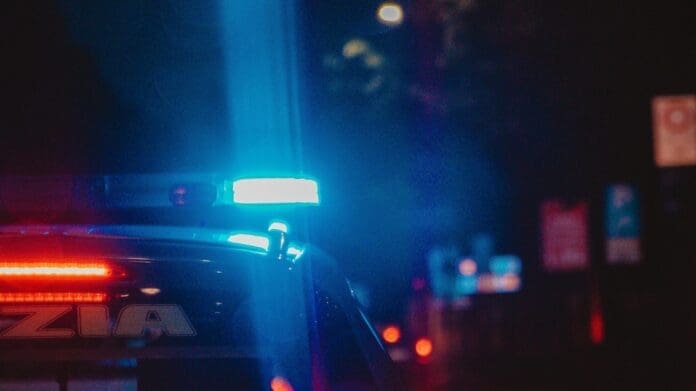 A police car installation on a street at night.