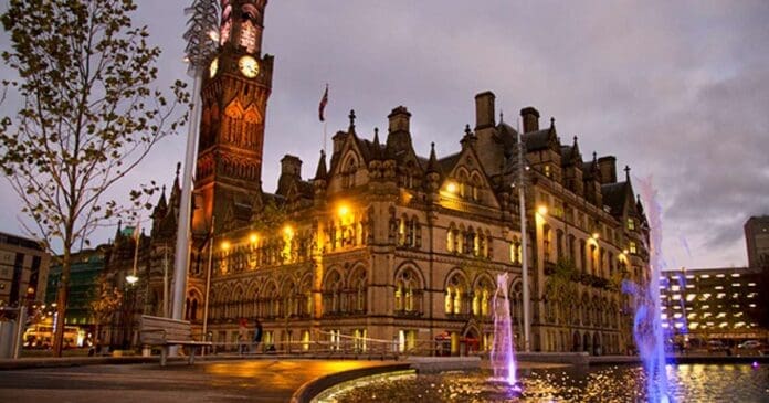 A large building with a clock tower highlighting the bassline and bhangra during Bradford Music Month.