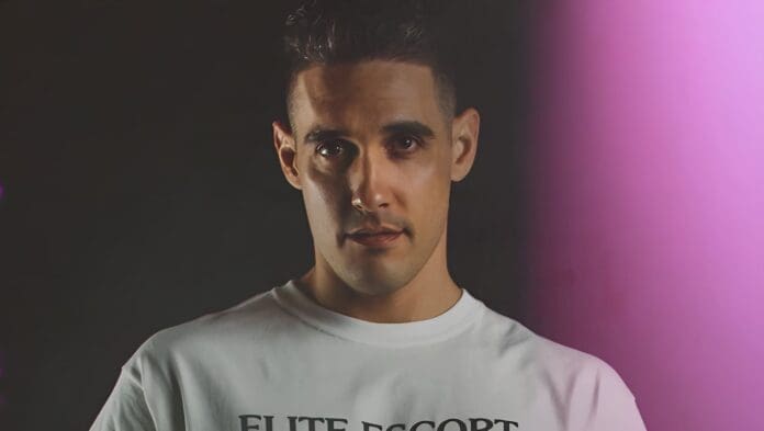 A man wearing an elite escort t-shirt.