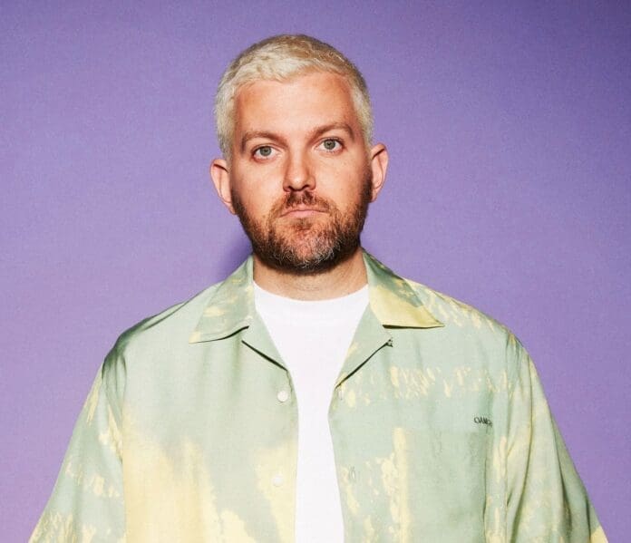 Dillon Francis Drops New Track 'I'm My Only Friend' standing in front of a purple background