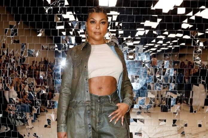 A woman is standing in front of mirrors at a fashion show.