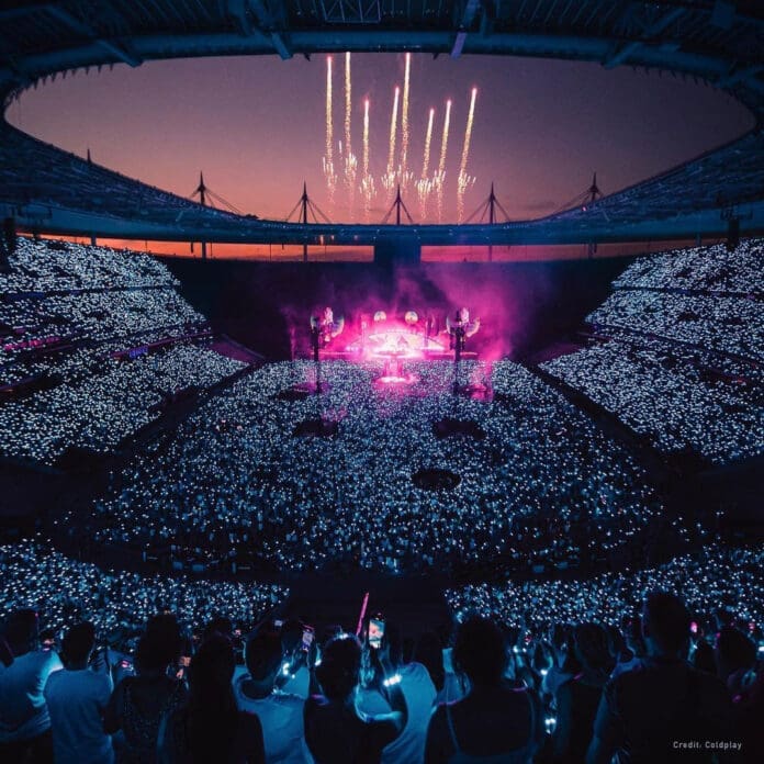 A stadium full of people experiencing a spectacular light show with PixMob.