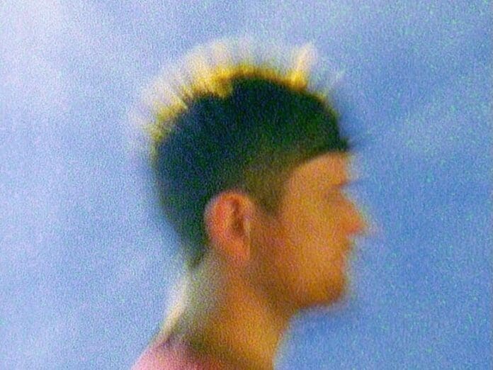 A blurry image of a man with spikes on his head, set against the fresh chillout soundscapes created by AI-Powered Endel.