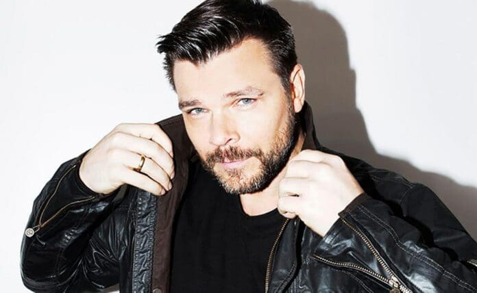 A man in a leather jacket posing for a photo during the North American Fall Tour.