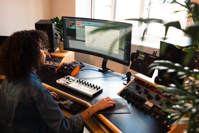 A woman working at a Beatport Studio desk.