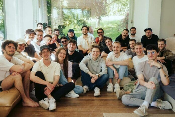 A group of people posing for a photo in a living room and creating memories for their joint album.