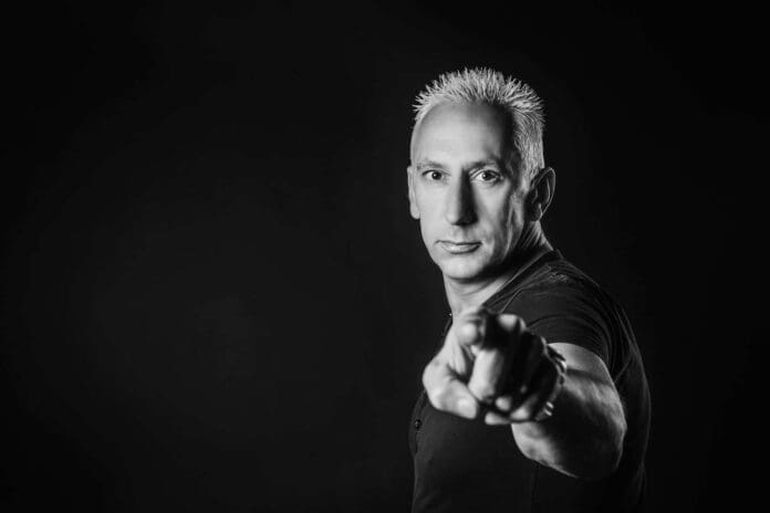 A black and white photo of a man pointing at something with a touch of Love From Above.