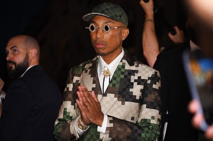 A man wearing a camouflage suit and glasses made from crocodile skin, catching the attention of onlookers while sparking controversy among animal rights activists such as PETA.